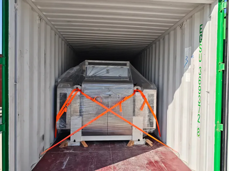 FO8100F oat flaking mill secured inside a shipping container with orange ratchet straps, export packing in place