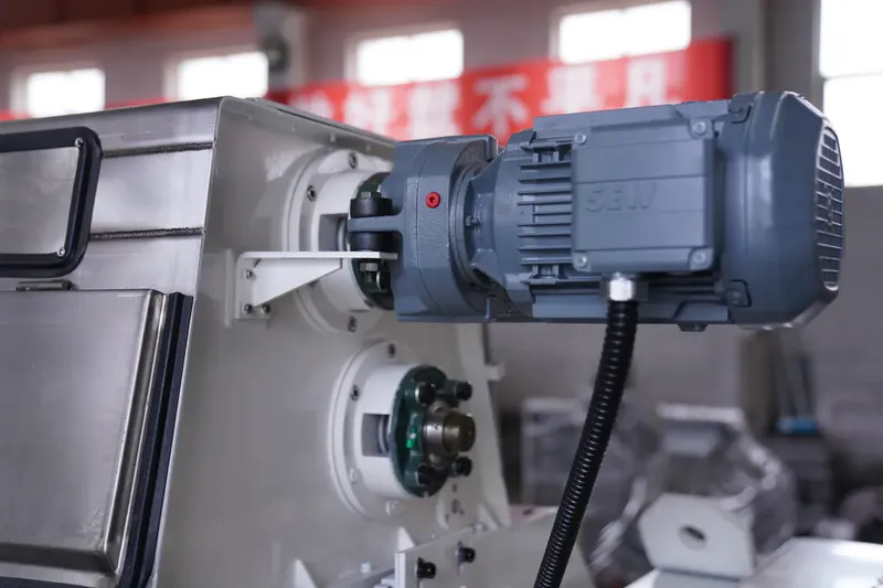 SEW variable-speed reducer on Bellaex oilseed flaker with balanced drive and bearing-temp monitoring.